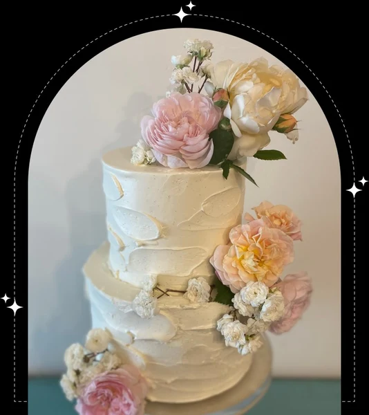Sweet Tartlette two-tier textured buttercream wedding cake dressed with fresh peonies and roses