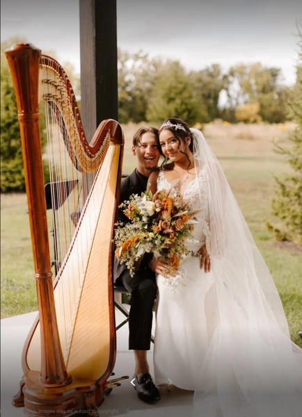 Maia Wachter- Harpist concert harp with a bride and groom outdoors on their wedding day
