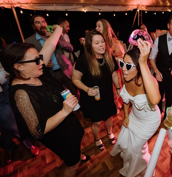 RD Entertainment bride and guests dancing under a tent at a wedding reception