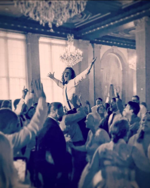 RD Entertainment guest lifted above a packed ballroom dance floor