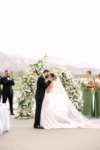 Artisan Event Floral Decor ceremony with white floral arches and a mountain backdrop