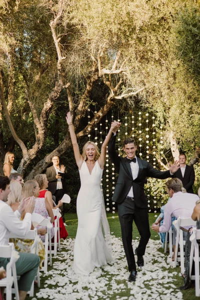 Artisan Event Floral Decor outdoor ceremony aisle lined with petals under olive trees