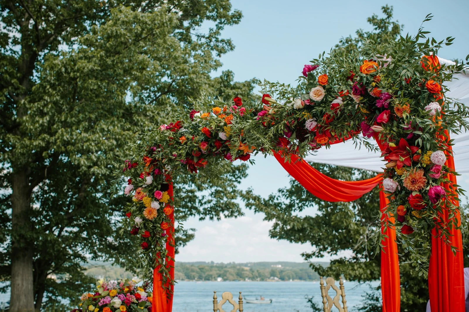 Folls' Flowers close view of a draped floral arch above the lake