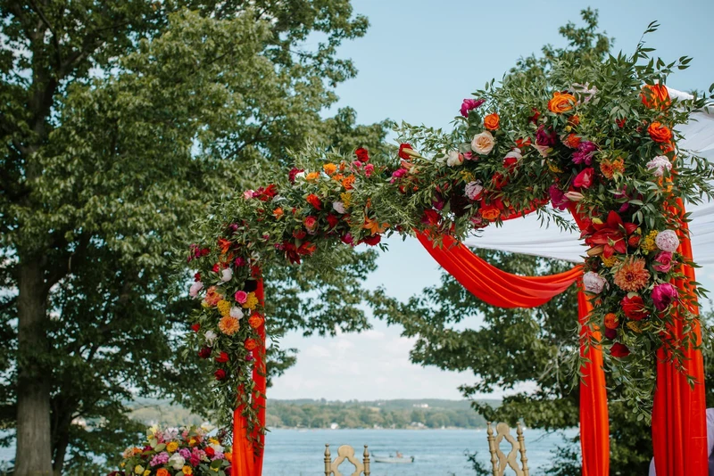Folls' Flowers close view of a draped floral arch above the lake