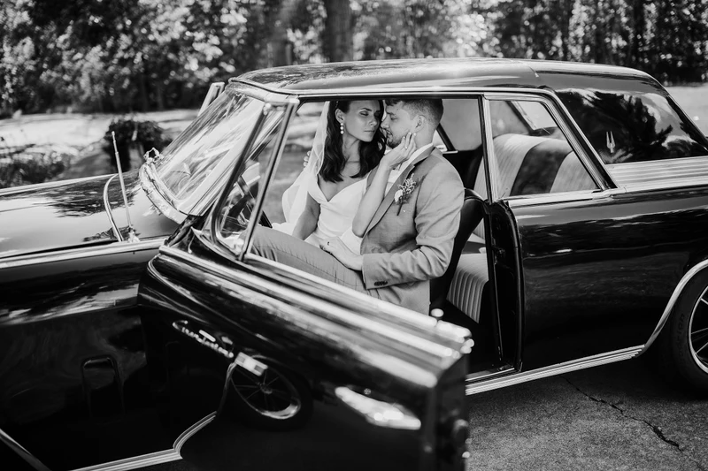 Addie Fath Photography black and white portrait of a couple in a classic car