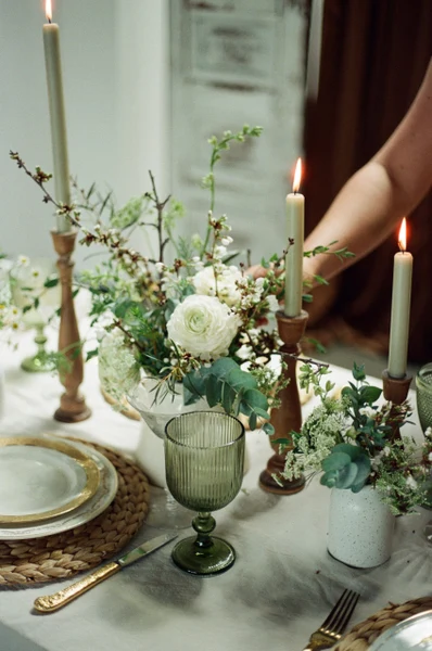 She Rents Vintage table with green goblets, taper candles in wooden holders and gold rimmed plates