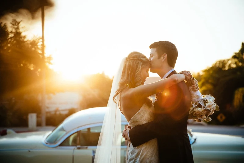 LEAF Wedding Photography bride and groom at golden hour beside a vintage car