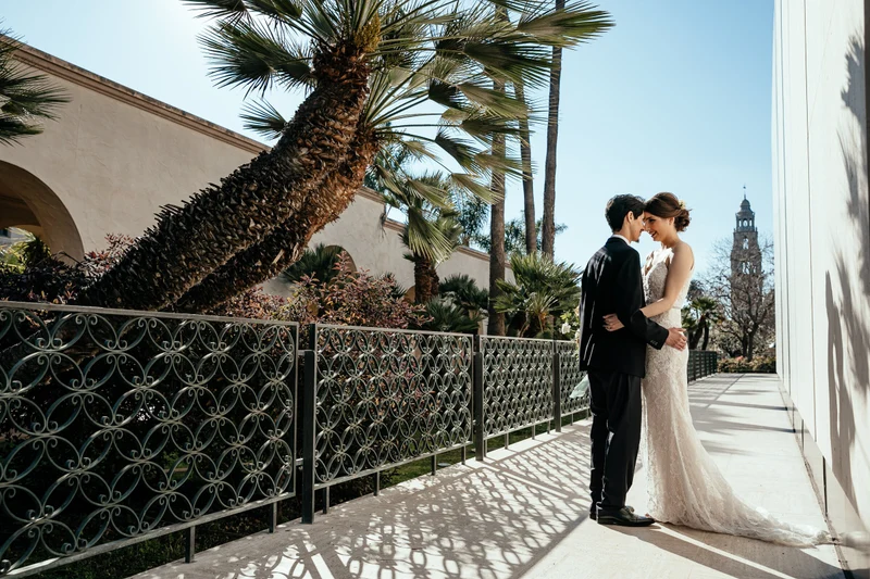 LEAF Wedding Photography couple on a sunlit walkway beneath palm trees