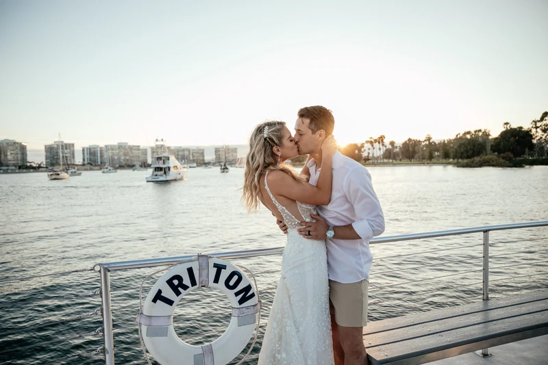 LEAF Wedding Photography couple kissing on a yacht deck at sunset