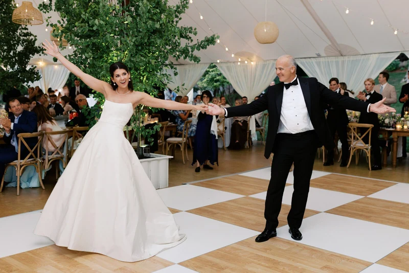 Anna Beth Smith bride dancing on a checkered floor under a reception tent