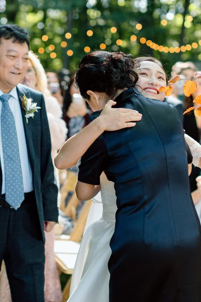 Anna Beth Smith bride hugging her mom at the end of the aisle during an outdoor ceremony