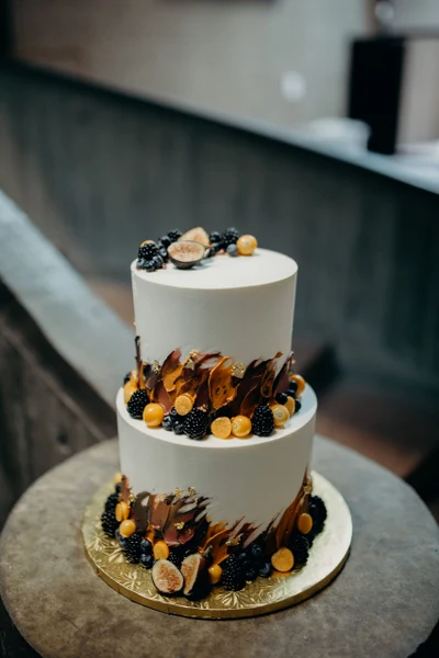 Sugar Blossom Cake Shop two-tier wedding cake decorated with chocolate shards, blackberries and figs
