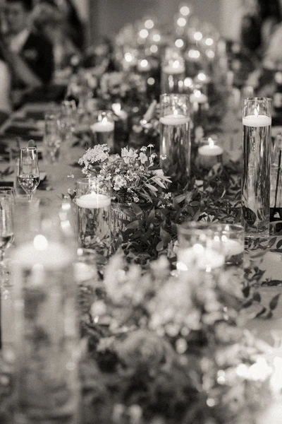 RD Events & Design candlelit reception table with floating candles and garden flowers, in black and white
