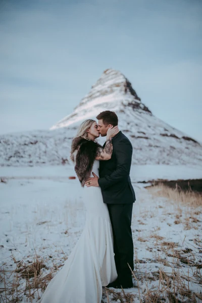 Joshua Veldstra Photography bride and groom kissing in front of a snow-covered mountain