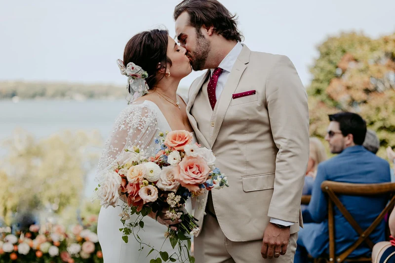 Bittersweet & Co. bridal bouquet in soft garden tones at a lakeside ceremony
