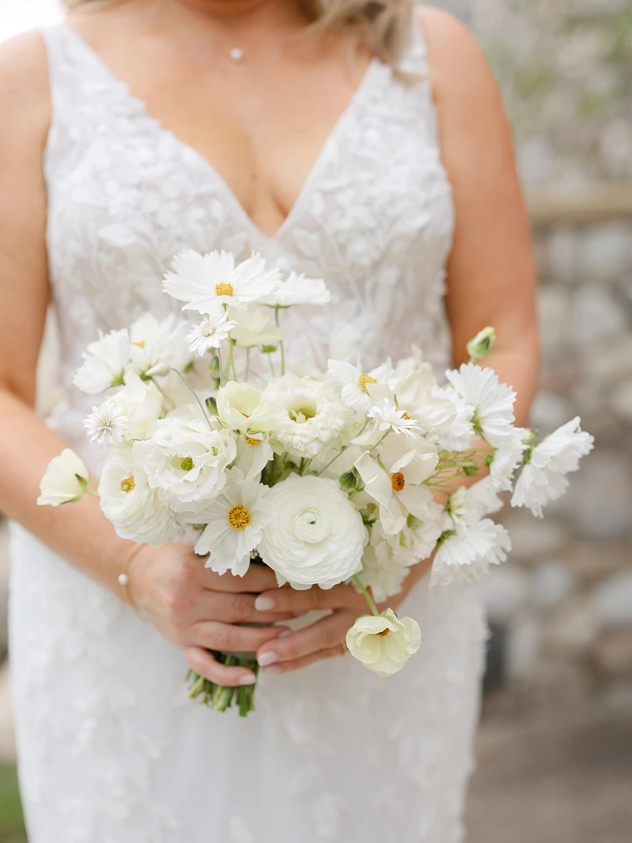 Bittersweet & Co. all white bridal bouquet held by the bride