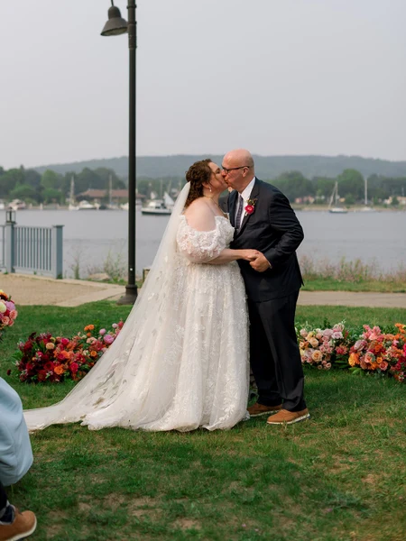 Bittersweet & Co. waterfront ceremony with colorful ground florals