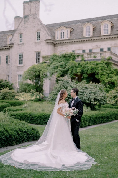 Eliza Jane Events couple standing in the formal gardens of a stone mansion
