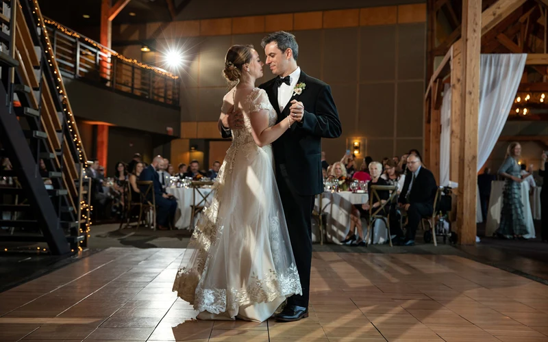 Jeffrey Foote Photography first dance in a timber barn hung with string lights