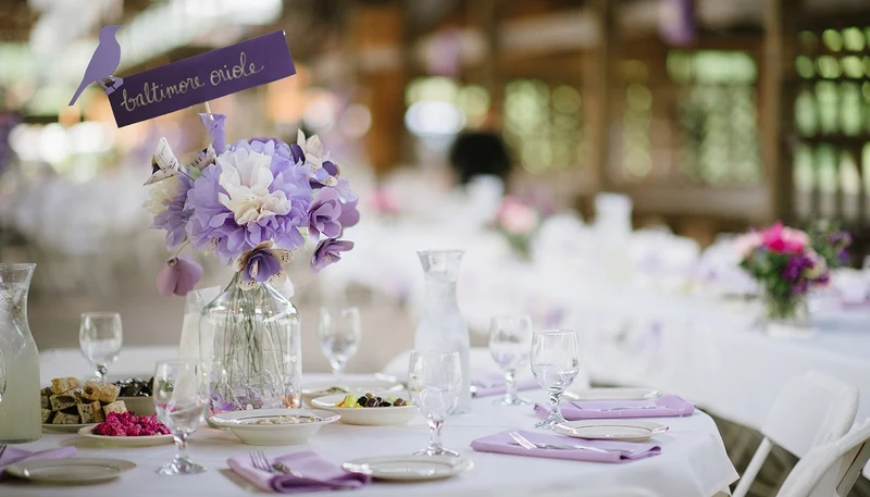 Ba-Li Cravings appetizers on a wedding reception table with lavender linens and flowers