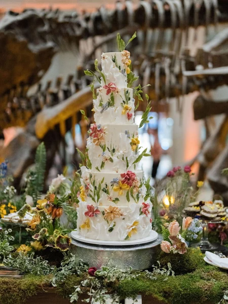 LILA Cake Shop tall tiered wedding cake covered in colorful buttercream flowers