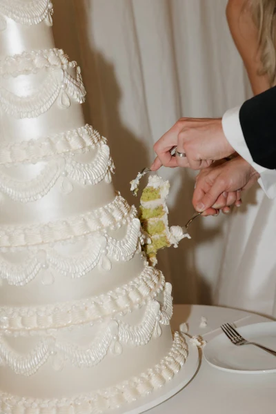 LILA Cake Shop vintage piped white wedding cake being cut