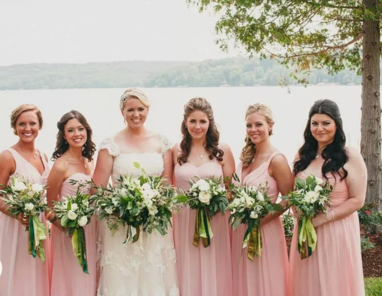 On-Site Bridal bride and five bridesmaids with soft waves and updos beside a lake