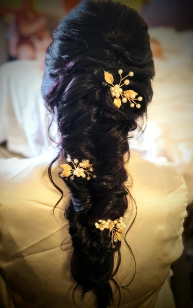 Styles by Lauren long bridal braid dressed with gold floral hair pins